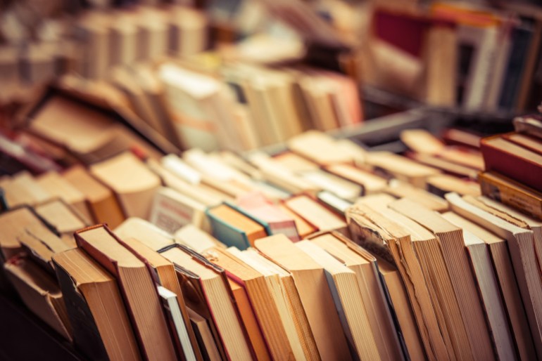 Many old books in a book shop or library. Shallow DOF