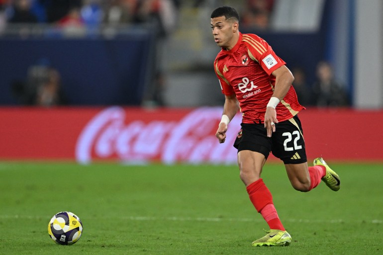 Ahly's Egyptian midfielder #22 Emam Ashour runs with the ball during the 2024 FIFA Intercontinental Cup football match between Mexico's Pachuca and Egypt's Al-Ahly at Stadium 974 in Doha on December 14, 2024. (Photo by Mahmud HAMS / AFP)